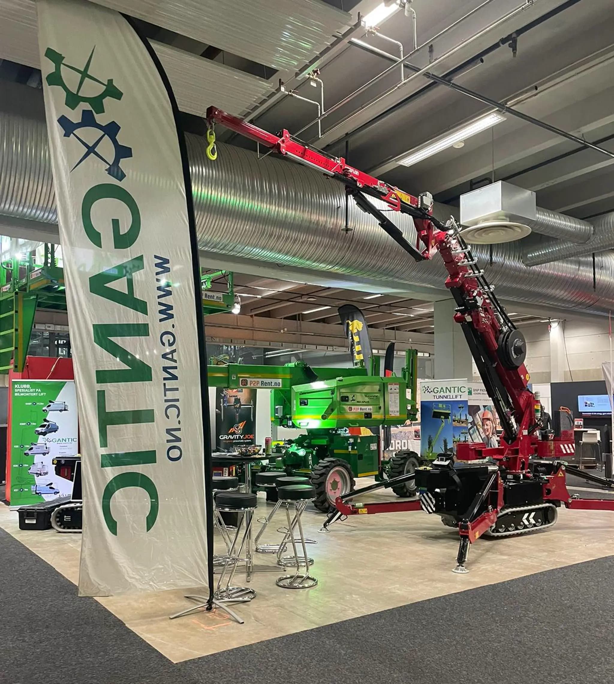 Hoeflon crane at a trade show booth with a Gantic banner.