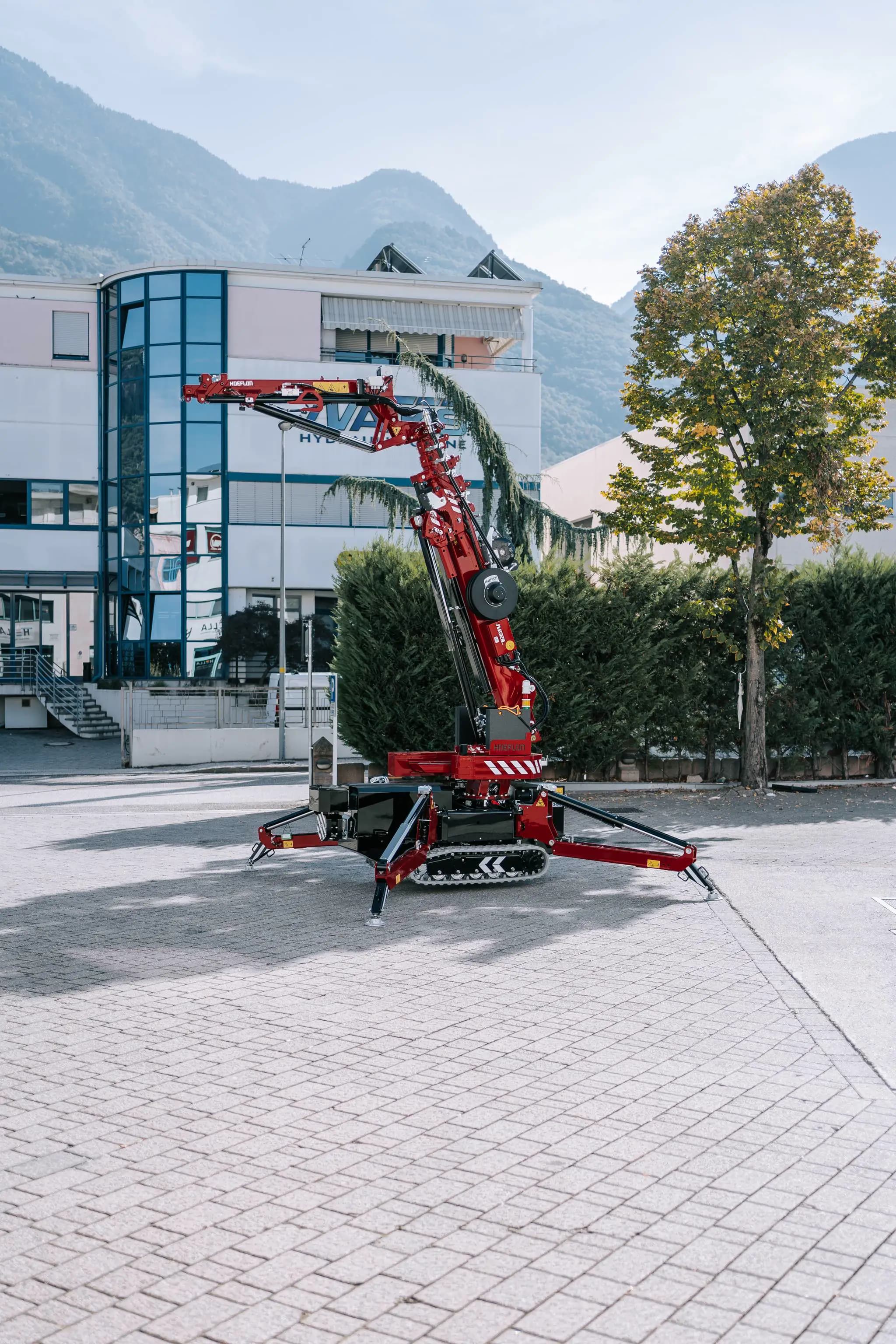 Hoeflon crane outside in front of a building.